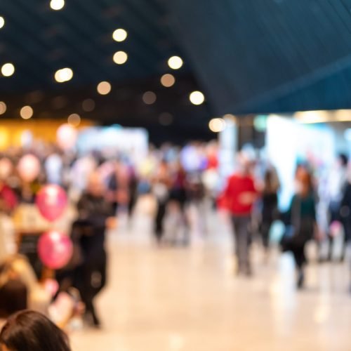 Blurred crowd of people in modern interior during event