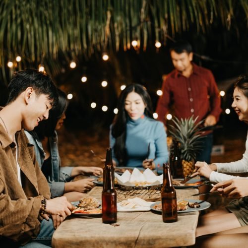 Goup of young Asians gather for a garden party.