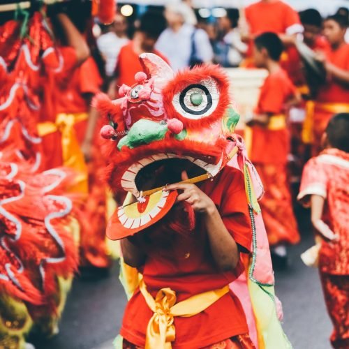 Lion dance during Chinese New Year celebration. Group of people perform a traditional lion dance.